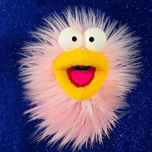 May include: A white ceramic mug with a black handle and the text "But First, Coffee" in a black, handwritten-style font. The mug is on a white surface.