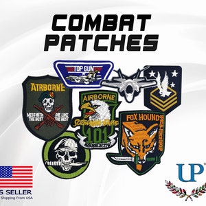 May include: A collection of embroidered patches featuring military and pop culture themes. Patches include "Airborne", "Top Gun", "Screaming Eagle 101", "Fox Hound Special Force Group", and a military rank patch.