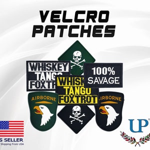 May include: A collection of embroidered patches with various designs, including skulls, eagles, and text. The patches are yellow, black, green, and white. The text on the patches reads "Whiskey Tango Foxtrot", "100% Savage", and "Airborne".