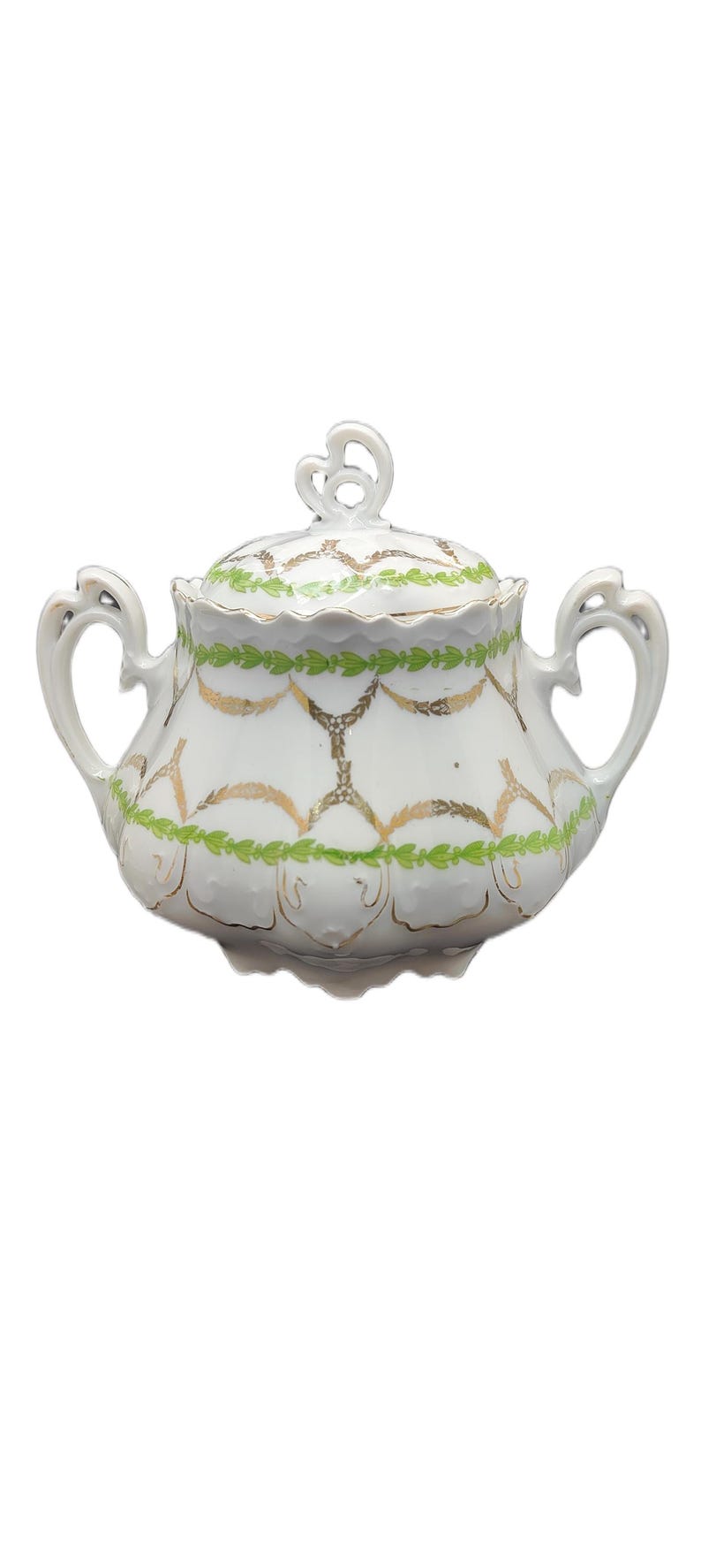 May include: White porcelain sugar bowl with lid, featuring gold and green decorative patterns. The bowl has two handles and a decorative finial on the lid. A classic piece for serving sugar.