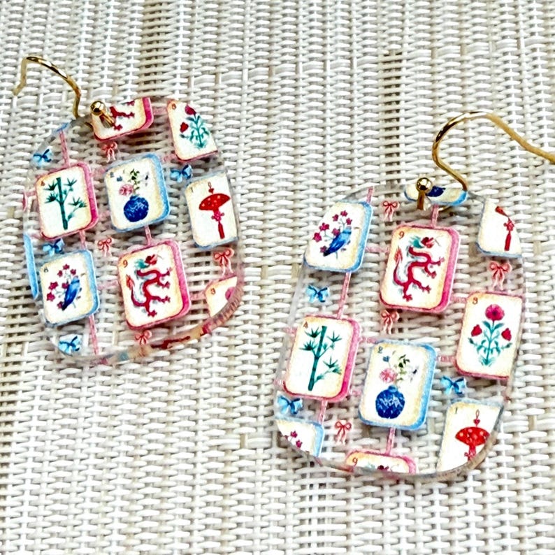 Clear acrylic mahjong earrings with playful tile pattern and glossy finish