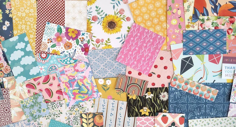 May include: A collage of patterned paper sheets in various designs and colors. Floral, fruit, and geometric patterns are visible, including sunflowers, watermelons, and kites. The color palette includes pink, blue, yellow, and red.