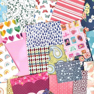May include: A collection of colorful patterned paper sheets. Designs include hearts, rainbows, clouds, floral, and geometric patterns. The color palette is diverse, featuring pink, blue, yellow, and red hues. Ideal for scrapbooking, card making, and other paper crafts.