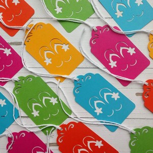 May include: A set of ten colourful paper gift tags with a cut-out design of fireworks. Each tag has a string attached for hanging.