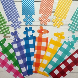 May include: A set of 10 colourful gingham fabric bookmarks with a white flower design. Each bookmark is approximately 15 cm long and features a different colour gingham pattern.