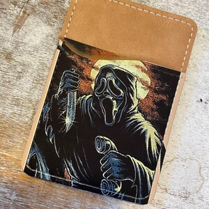 Cartera para teléfono con cara de fantasma