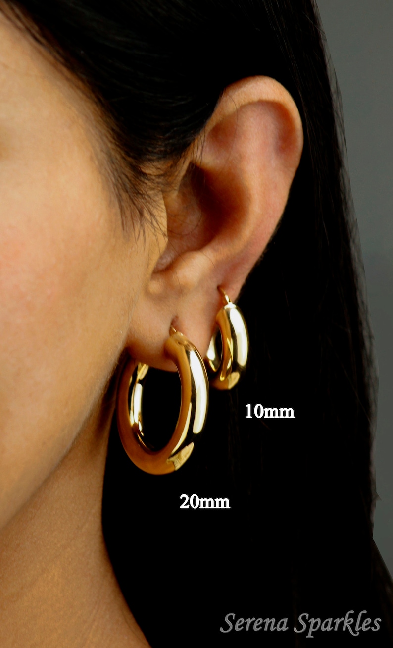 May include: A close-up of a person's ear wearing three gold hoop earrings. The earrings are 10mm, 20mm, and 30mm in diameter. The text "Serena Sparkles" is visible at the bottom of the image.