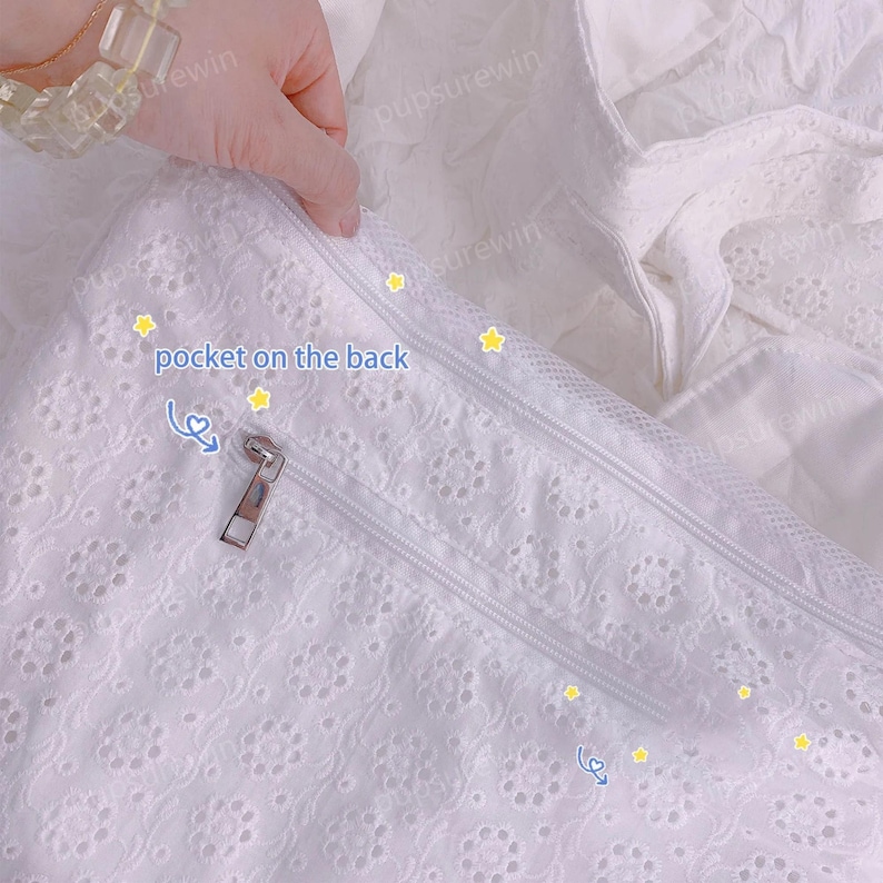 May include: White lace fabric with a zipper and the text "pocket on the back".