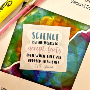May include: A white sticker with a blue cloud shape containing the text "SCIENCE IS A WILLINGNESS TO accept facts EVEN WHEN THEY ARE OPPOSED TO WISHES - B.F. Skinner".