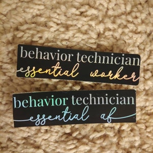 May include: Two black rectangular stickers with white and iridescent text. The top sticker reads "behavior technician essential worker". The bottom sticker reads "behavior technician essential af".