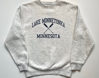 May include: A gray sweatshirt with a navy blue print that says "LAKE MINNETONKA MINNESOTA" with two crossed oars.