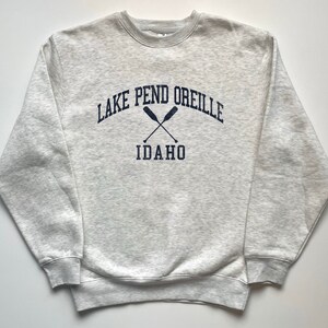 May include: Gray sweatshirt with a navy blue print that says "Lake Pend Oreille Idaho" with two crossed oars.