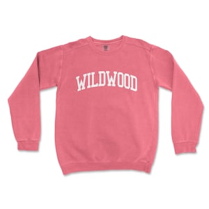 a pink sweatshirt with the word wildwood printed on it