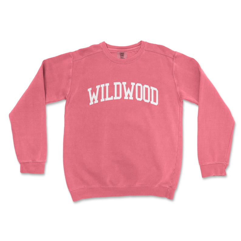 a pink sweatshirt with the word wildwood printed on it