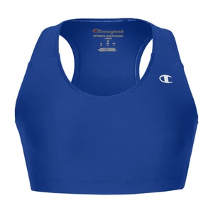 May include: Royal blue sports bra with a racerback design and a white Champion logo on the right side. The bra has a scoop neck and is made of a moisture-wicking fabric.