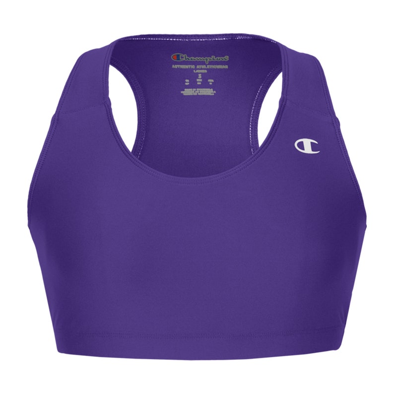 May include: Purple sports bra with a white Champion logo on the right side. The bra has a racerback style and a scoop neck.