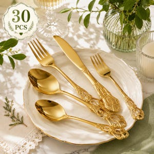 May include: A 30-piece gold-toned flatware set featuring ornate, embossed handles with intricate detailing. The set includes a dinner fork, a dinner knife, a salad fork, a soup spoon, and a teaspoon, all arranged on a white scalloped plate.