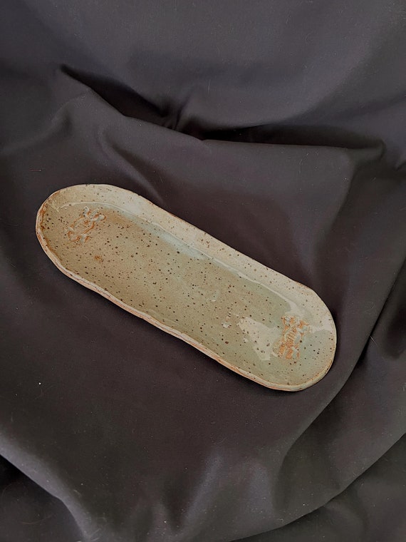 Rustic handmade oval celadon stoneware tray with lizard details