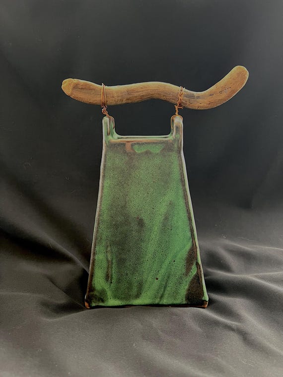 Handmade stoneware vase with driftwood