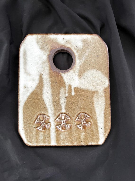 Rustic handmade stoneware charcuterie or cheese board with pressed detail