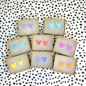 May include: Assortment of colourful Mickey Mouse ear stud earrings in various colours, including blue, pink, yellow, and orange. The earrings are displayed in small square boxes.