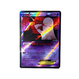 May include: A holographic trading card featuring a female character with long blonde hair and red eyes. The card is titled "Kiss-Shot" and has a red and black background with Japanese text. The card has a description of the character's abilities, "Vampire form" and "Kokorowatari-Edge".