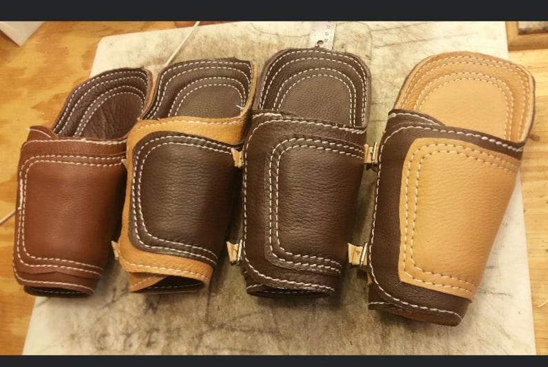 Pu&ograve; includere: Quattro braccialetti in pelle per il polso con cuciture decorative. Due sono marroni e due sono beige.