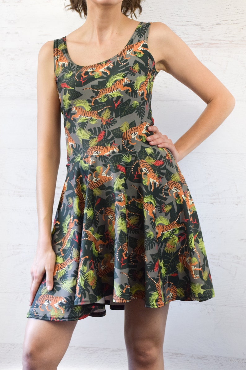 May include: A gray sleeveless dress with a print of orange and black tigers in a jungle setting.