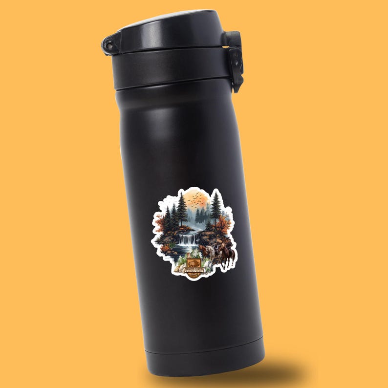 May include: Black stainless steel water bottle with a sticker of a forest scene with a waterfall, a full moon, and a group of deer. The sticker says "National Wildlife"
