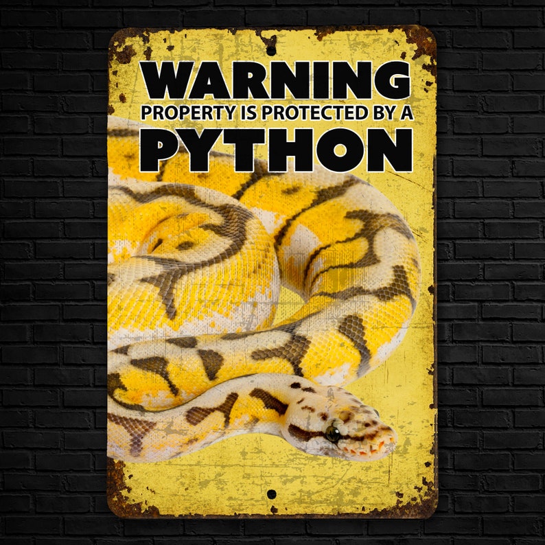 May include: Yellow metal sign with the text "WARNING PROPERTY IS PROTECTED BY A PYTHON" in black letters. A yellow and black python is curled up on the sign.