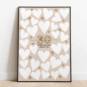 May include: A printable sign with a beige background and white hearts. The sign says "Thirty Things We Love About You" with a gold glitter "thirty" in cursive.