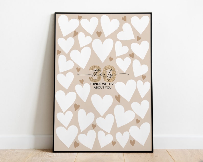 May include: A printable sign with a beige background and white hearts. The sign says "Thirty Things We Love About You" with a gold glitter "thirty" in cursive.