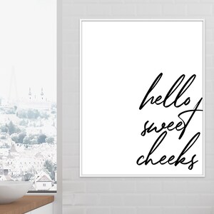 May include: Black and white printable wall art with the text "hello sweet cheeks" in a cursive font.