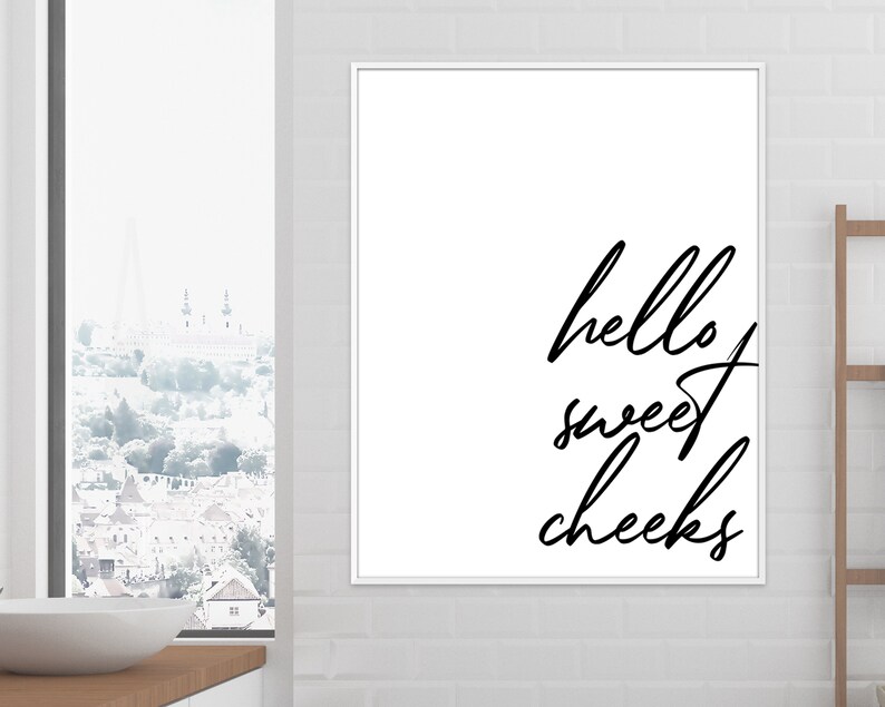 May include: Black and white printable wall art with the text "hello sweet cheeks" in a cursive font.