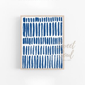 May include: A framed abstract print with a white background and a pattern of blue brushstrokes.