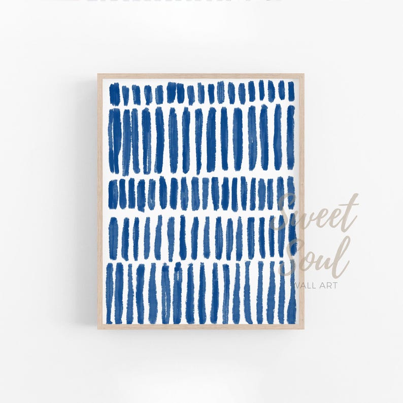 May include: A framed abstract print with a white background and a pattern of blue brushstrokes.