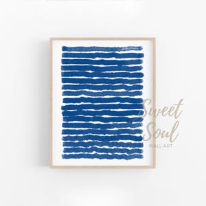 May include: Abstract art print featuring a blue and white colour scheme. The print displays a series of horizontal lines in a deep blue colour, creating a textured and modern look.