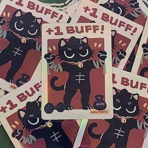 May include: A collection of trading cards featuring a black cat character with a gold bell collar and a weightlifting theme. Each card has the text "+1 BUFF!" and the word "BUFF" on a weight. The cards have a red background.