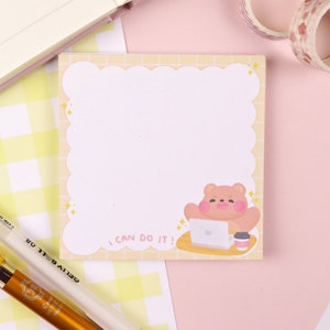 May include: A yellow and white checked background with a sticky note featuring a cartoon bear sitting at a laptop with a cup of coffee. The sticky note has a scalloped border and the text "I can do it!" in a handwritten font.