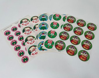 May include: Assortment of Christmas themed stickers featuring Santa Claus, a Christmas tree, a candy cane, a wreath, and a mouse holding a stocking. The stickers are printed on white sheets.