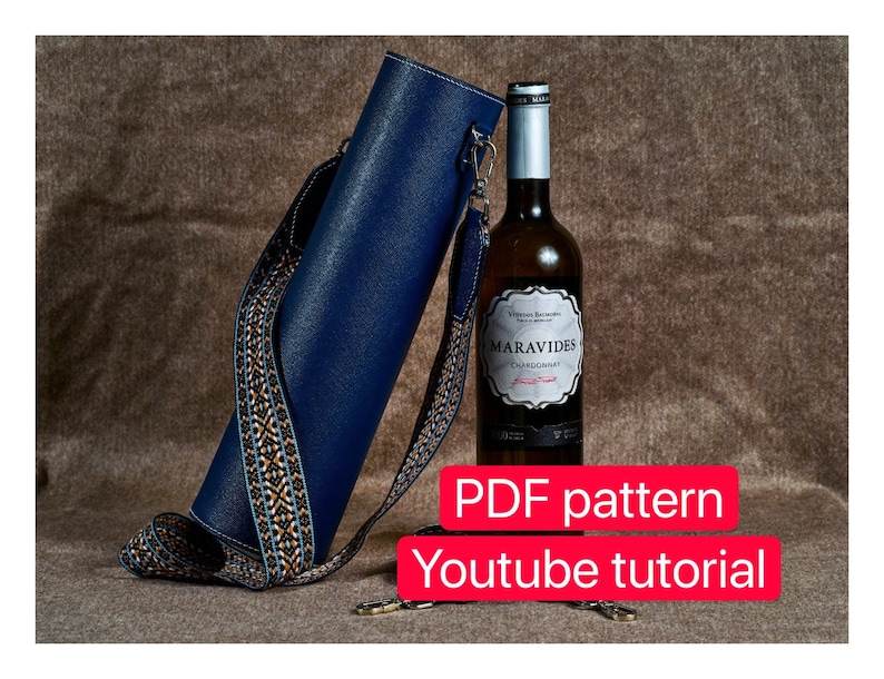 May include: A blue leather wine bottle carrier with a patterned strap. The carrier is holding a bottle of white wine with a label that reads "Maravides Chardonnay". The image also includes the text "PDF pattern" and "Youtube tutorial".