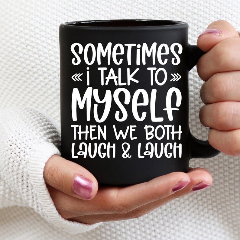 May include: Black coffee mug with white text that reads "Sometimes I talk to myself then we both laugh & laugh".