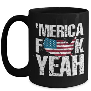 May include: A black ceramic mug featuring a distressed white graphic with the text 'MERICA F*CK YEAH and a central silhouette of the United States map filled with the American flag pattern of red, white, and blue stripes and white stars.