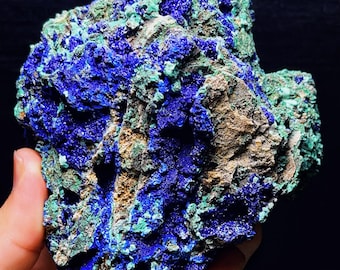 May include: A large, rough, blue and green azurite and malachite specimen. The mineral has a rough, textured surface with a mix of blue and green colors.