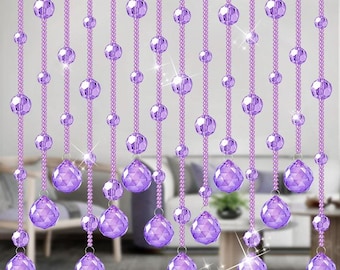 May include: A curtain made of strands of purple beads. Each strand has small, round beads and larger, teardrop-shaped beads.