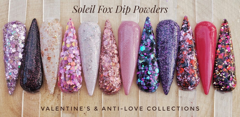 May include: A collection of Soleil Fox Dip Powders in various colors and textures. The nail samples showcase glitter, flakes, and solid colors, including pinks, purples, and reds. The text at the top reads "Soleil Fox Dip Powders" and the text at the bottom reads "Valentine's & Anti-Love Collections."