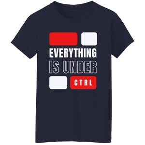 May include: Navy blue t-shirt with white text that reads "Everything is under CTRL" with red and white blocks representing computer keys.