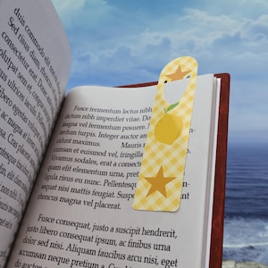 May include: A yellow and white bookmark with a lemon and star design. The bookmark has a checkered pattern and the text "Fusce consequat, justo a suscipit hendrerit, justo libero consequat ipsum, ac finibus urna dolor sed nisi. Aliquam faucibus arcu nisi, eget accumsan neque pretium a"