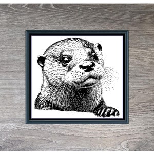 May include: Black and white cross-stitch pattern of an otter's face. The pattern is framed in a dark wood frame and set against a woodgrain background. The text "Otter" and "230 x 215" are below the image.