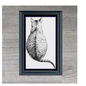 May include: Black and white cross-stitch pattern of a cat sitting with its back to the viewer, framed in a black frame with a gray wood background. The title "Cat Selfie" is below the image.